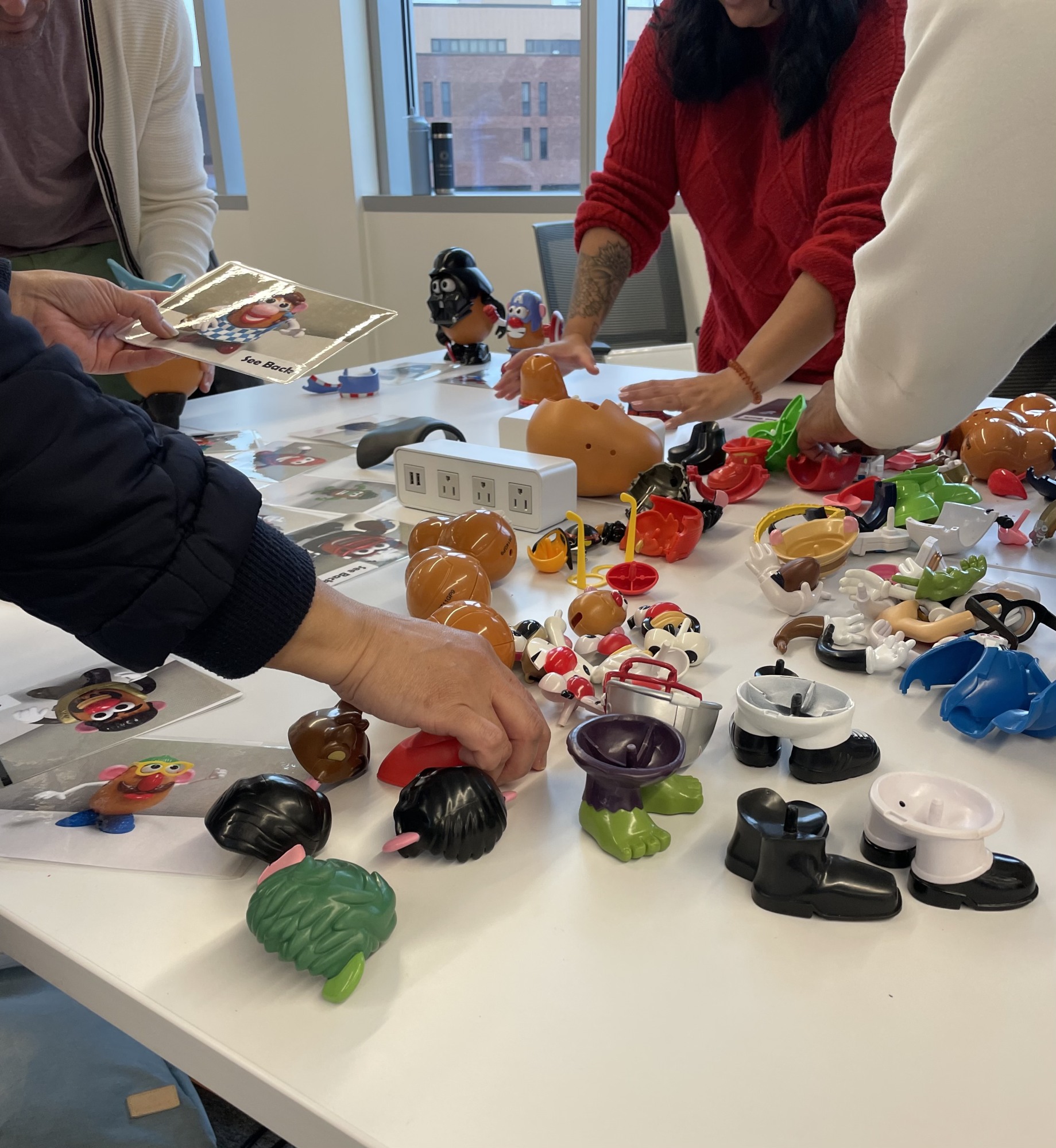 students assembling parts from many Mr. Potato Head toys
