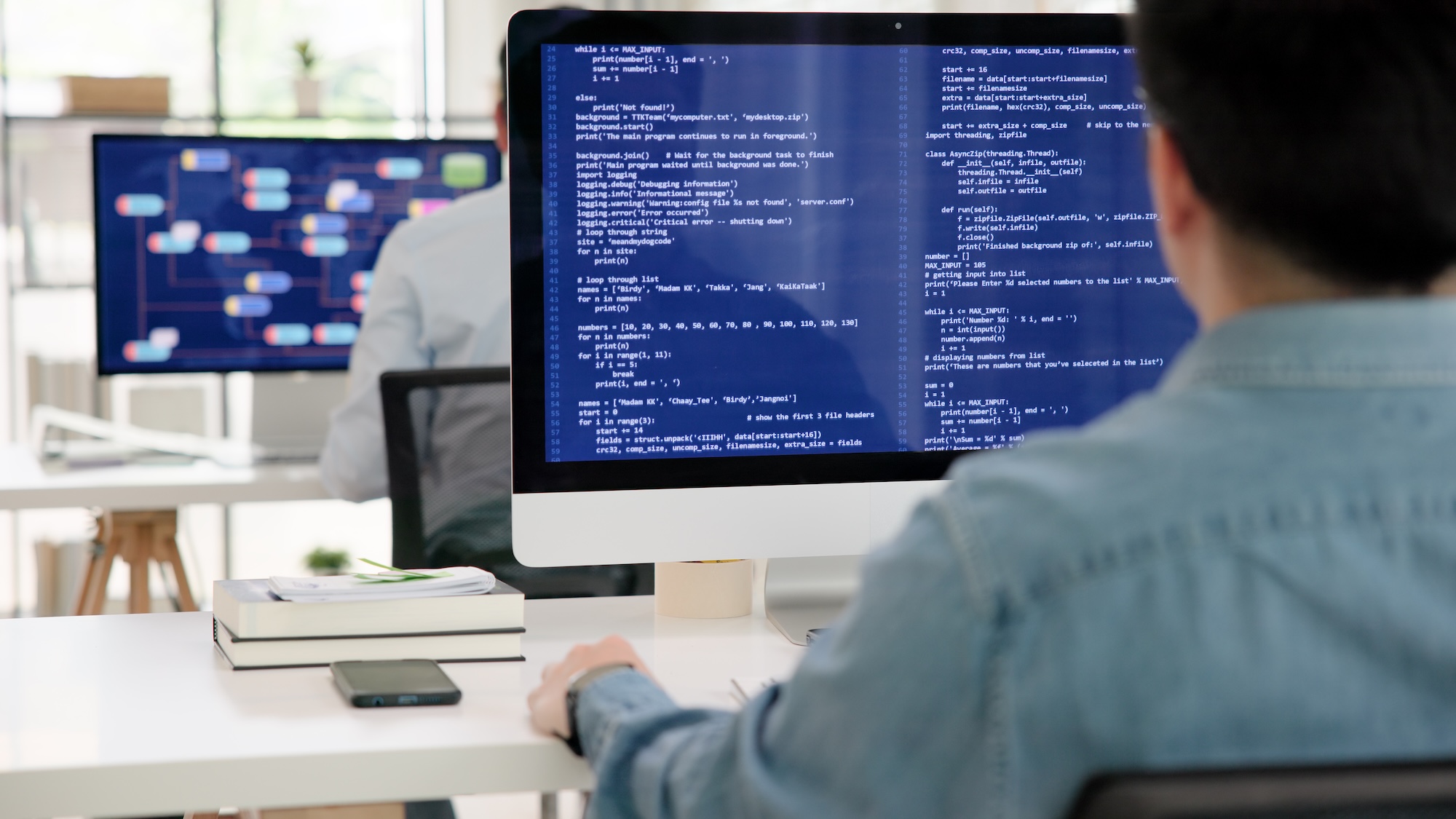 Man typing code on a computer