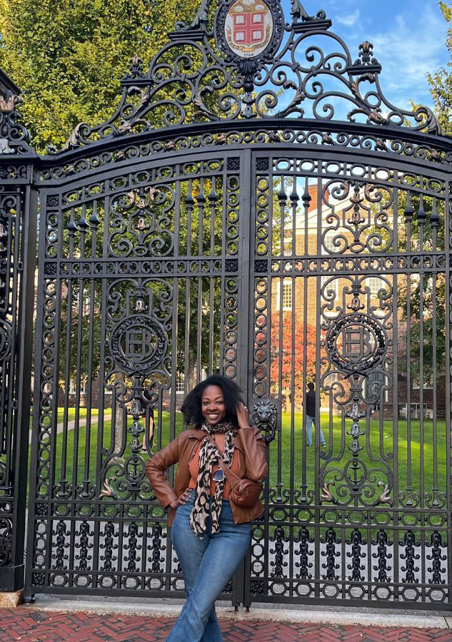 Amber Adams standing in front of Brown University Van Wickle Gates