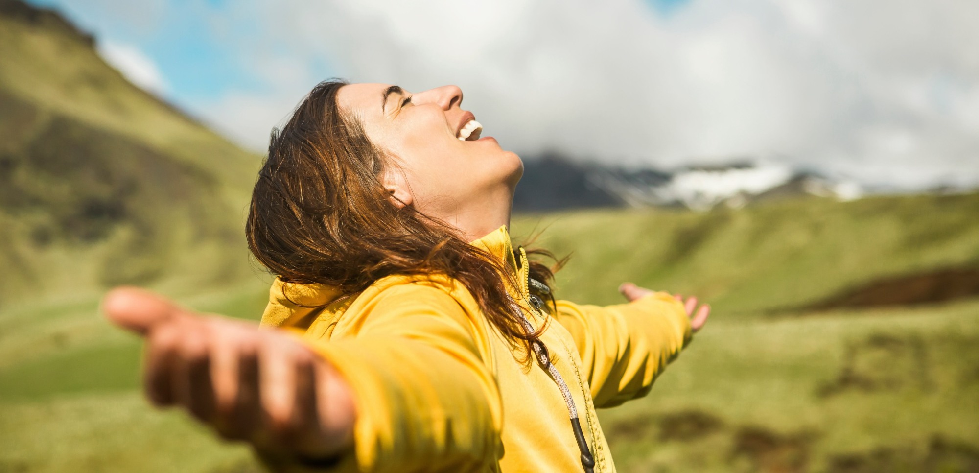 woman with her chin up to the sky, eyes closed, smiling