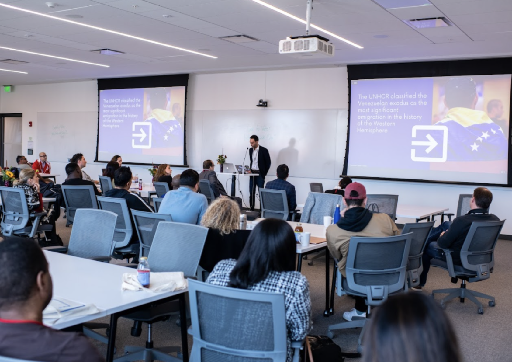 student presenting in front of full classroom