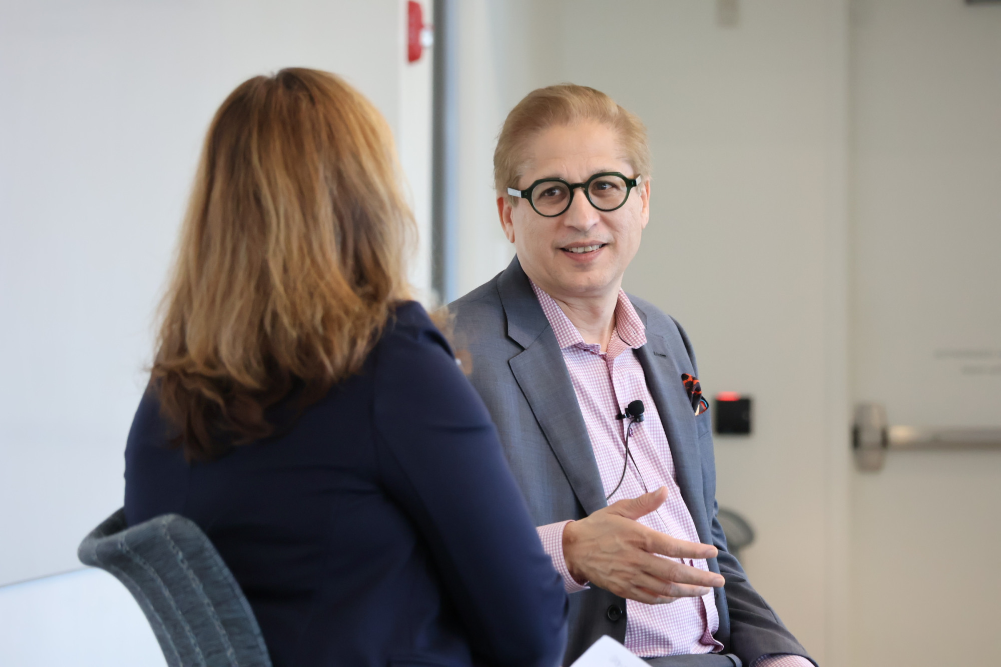 Fahim Siddiqui sits with SPS Dean Sandra Smith