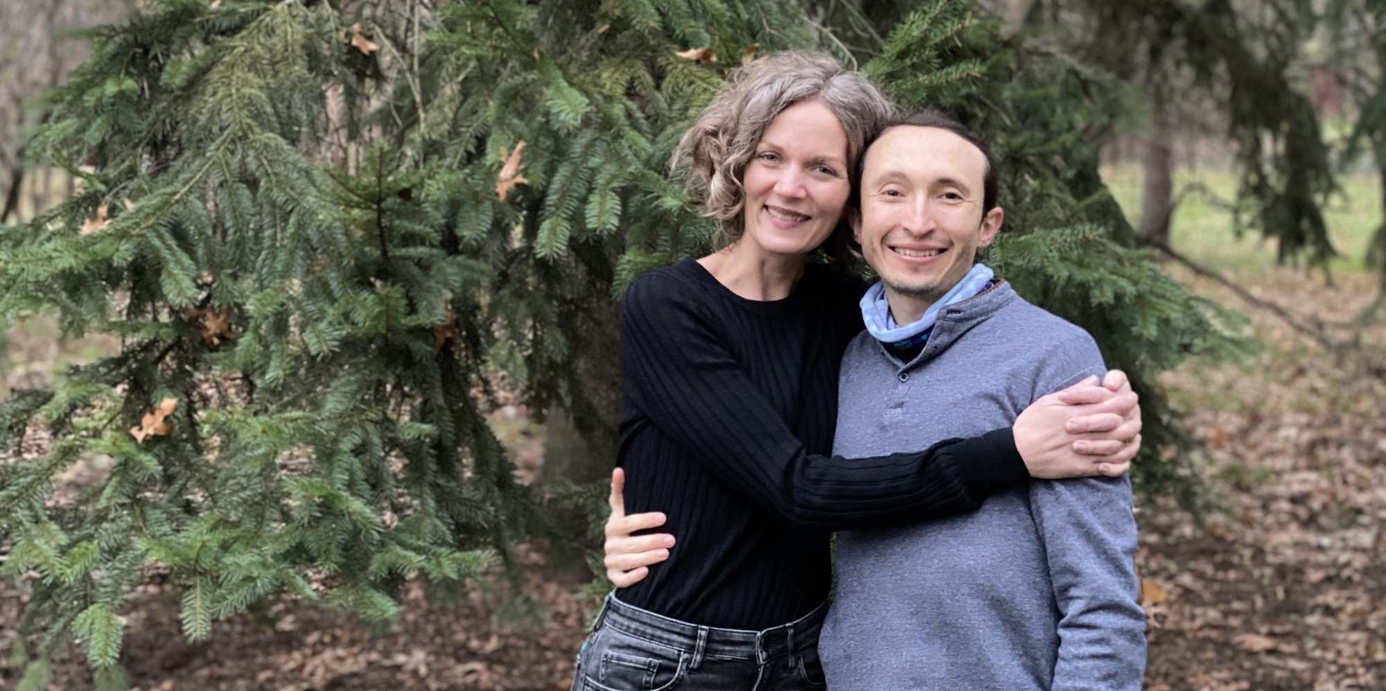 photo of Michelle and Hugo standing in front of a tree