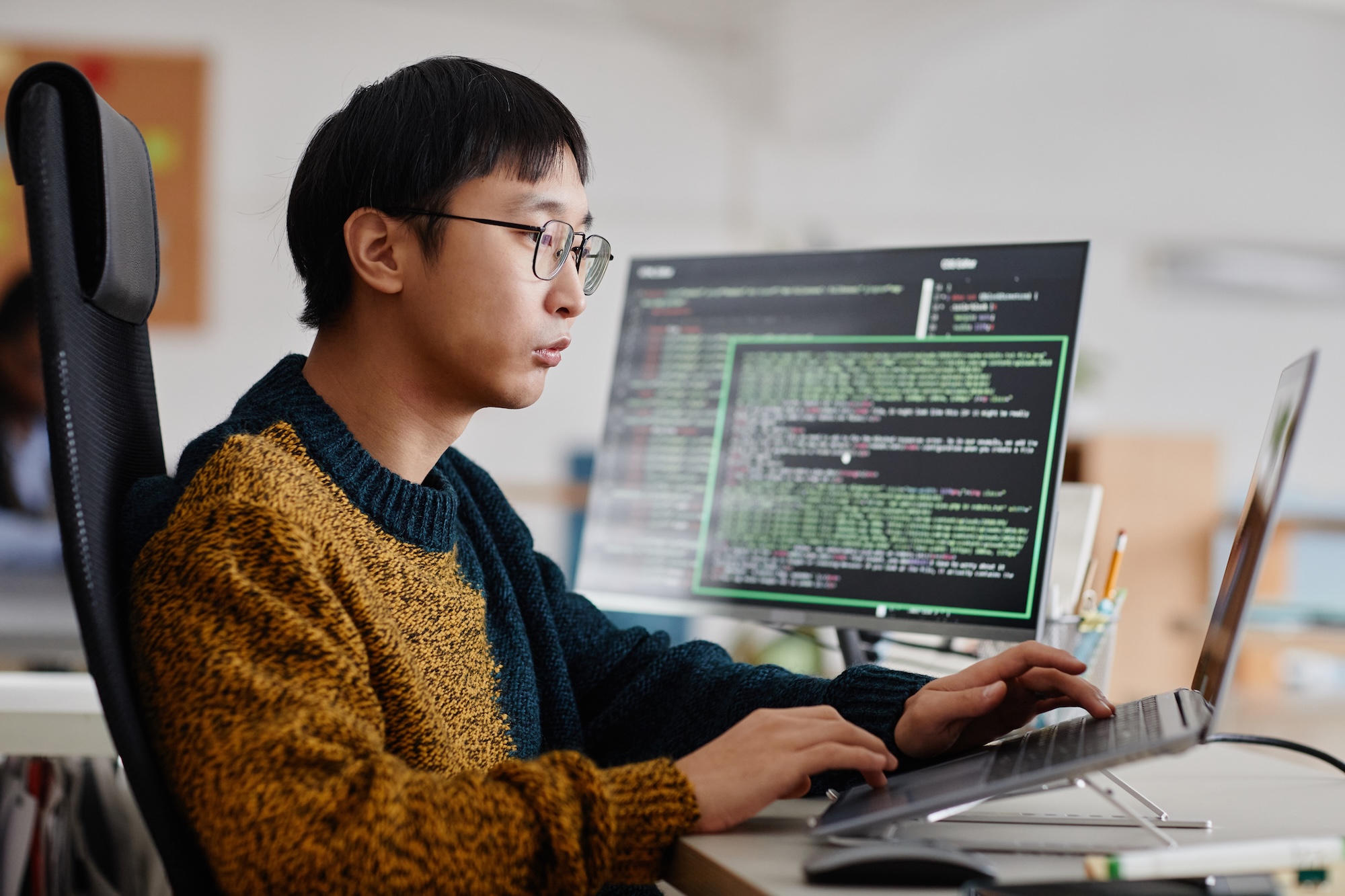 Man typing code on a computer
