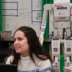 photo of female student sitting in computer science robotics lab