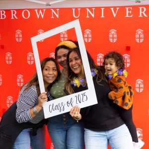 family smiling in family weekend photobooth