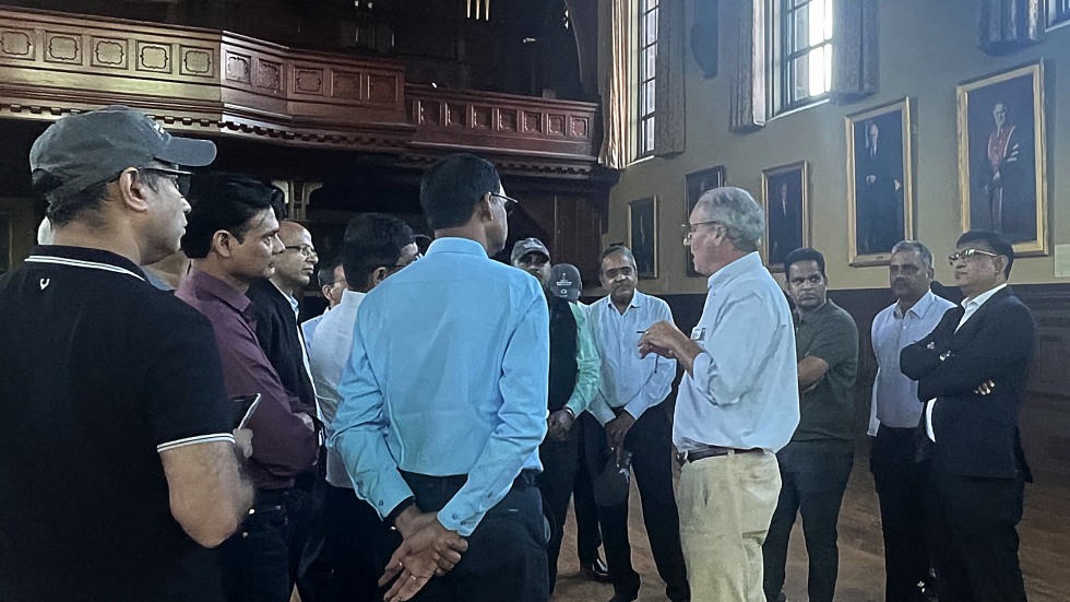 student participating in changing the tires in a pit crew style 