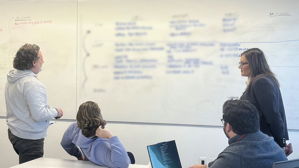 students working together on a whiteboard